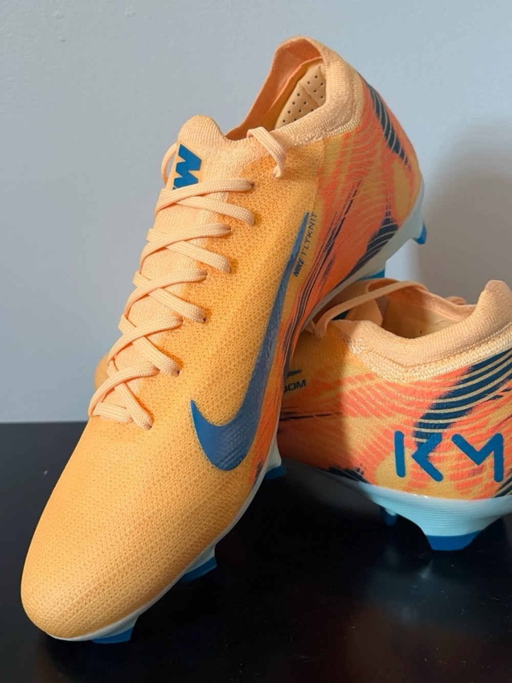 Nike Peach Orange Soccer Cleats with Blue Accents